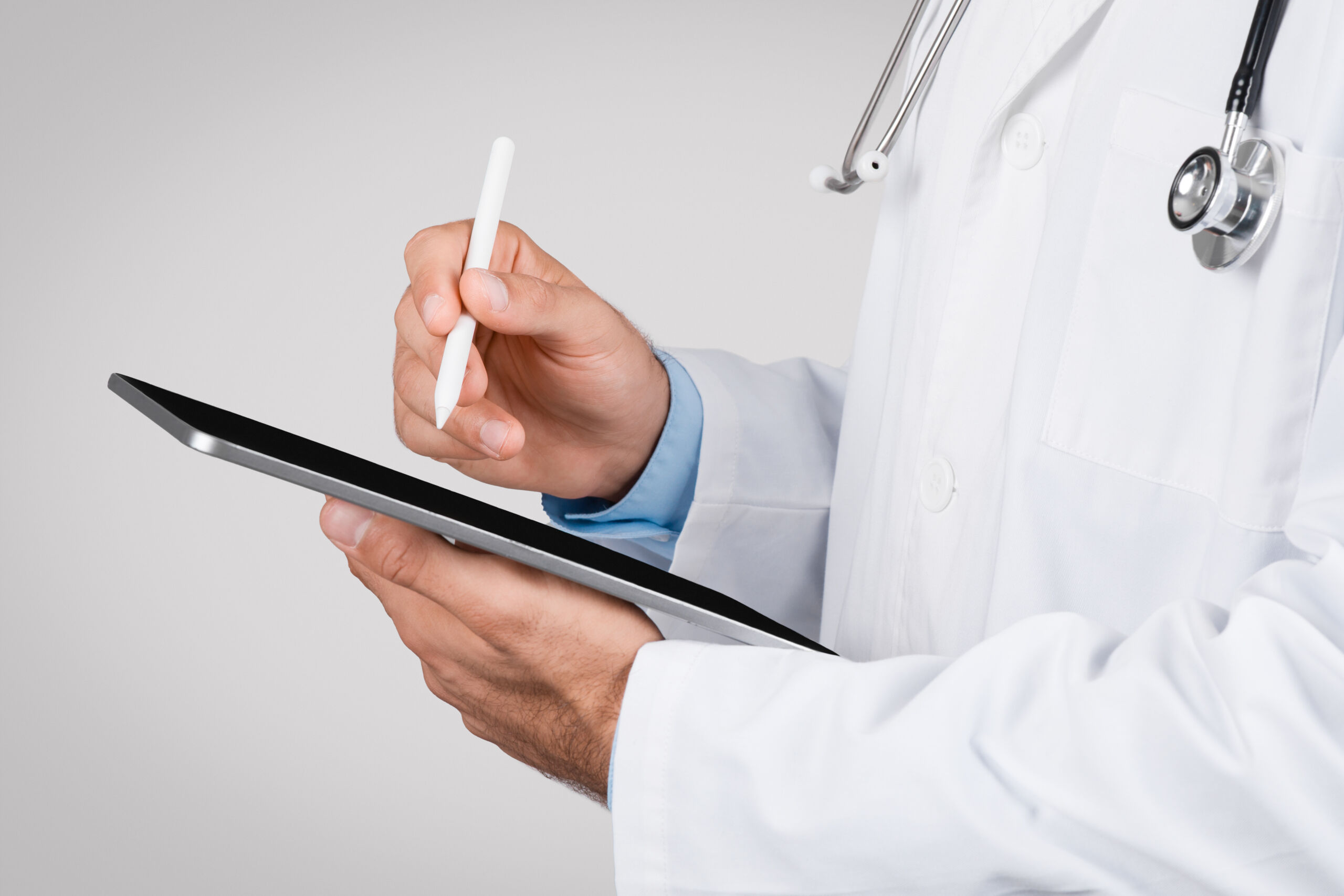 Doctor Referral Needed to Schedule Treatment | Daphne, AL Doctor using a tablet to process a medical referral so a patient can schedule treatment services in Daphne, Alabama (Baldwin County).
