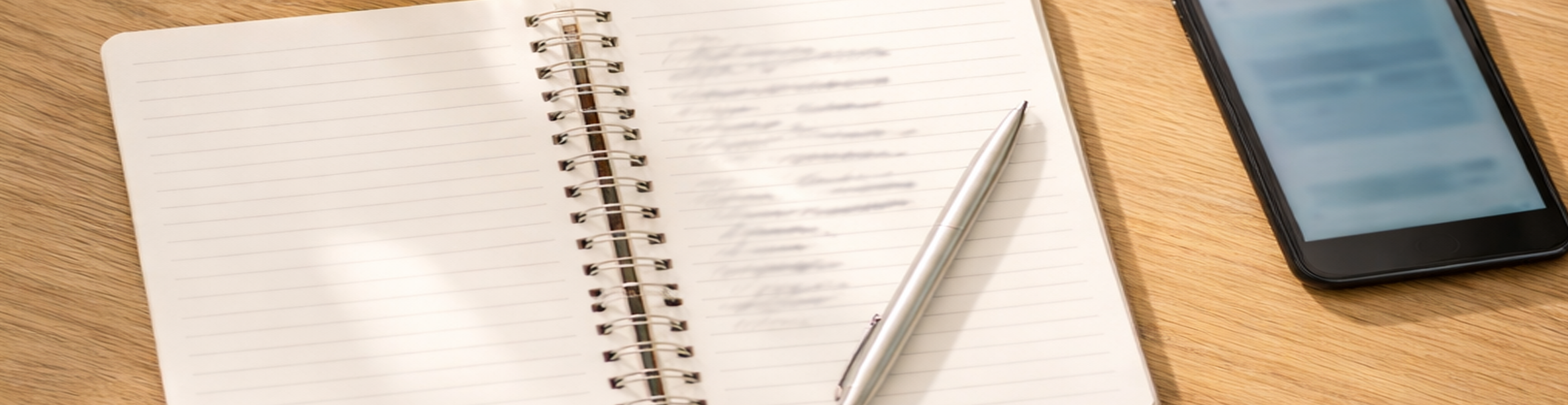 Home speech therapy practice setup on a wooden table with water, timer, notebook, and phone, representing adult communication exercises in Daphne, Alabama.